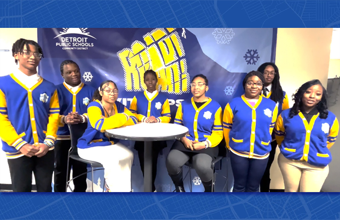  8 seniors on the Executive Youth Council standing and sitting in front of a Roar and Rise backdrop